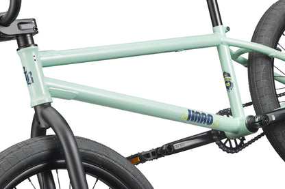Close-up of the Burgess, a versatile light green BMX bike with black handlebars, wheels, and crankset.