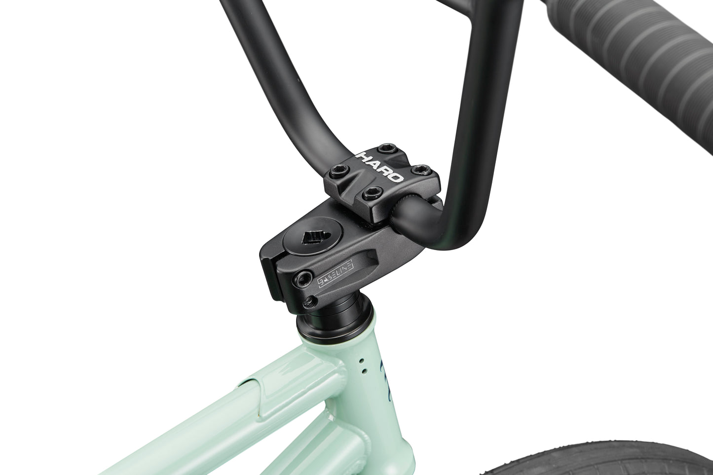 Close-up of a Burgess BMX handlebar and stem on a light green bike, featuring wrapped grips for versatile, high-level riding.