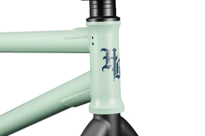 Close-up of a mint green Burgess frame, perfect for advanced riding, with a gothic-style H logo on the head tube.