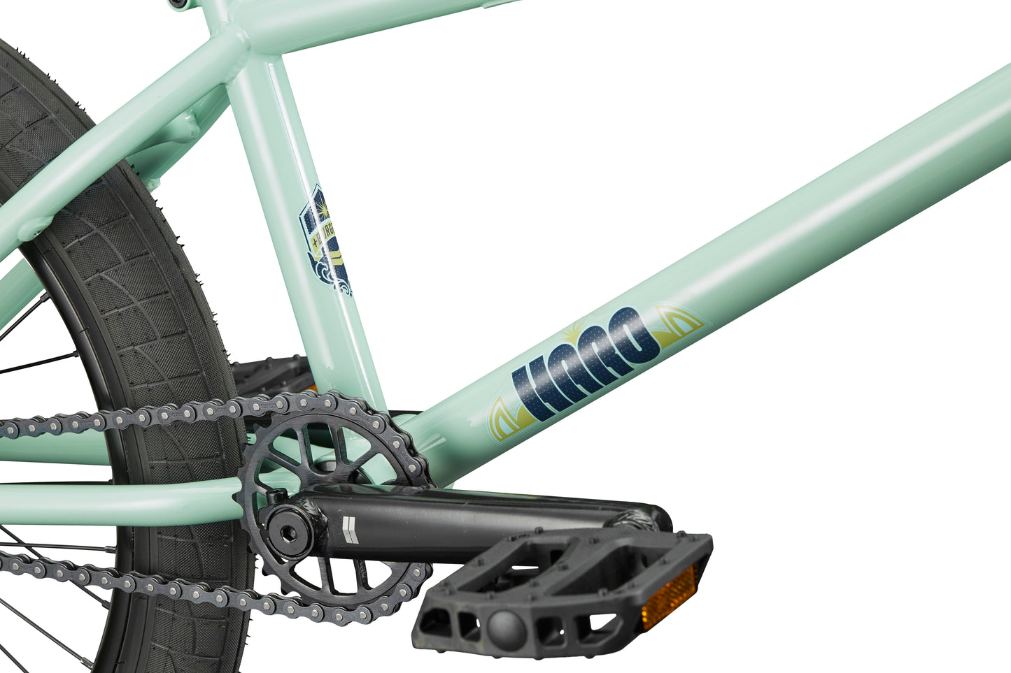 Close-up of the Burgess light green BMX frame with chain, pedal, rear tire, and KINK brand—ideal for advanced riders.