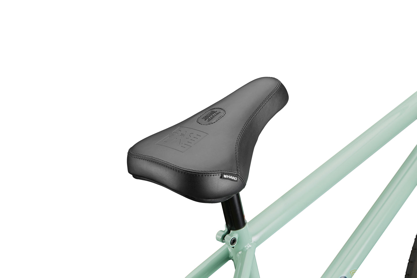 Close-up of a black seat on the light green Burgess BMX bike, designed for high-level riding, shown from the side on a white background.
