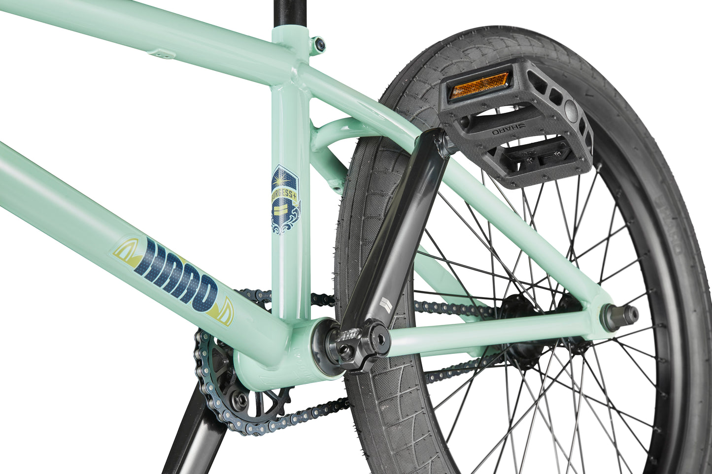 Close-up of the Burgess BMX bike's rear wheel, pedal, crank, and chain highlighting frame details and tire tread.