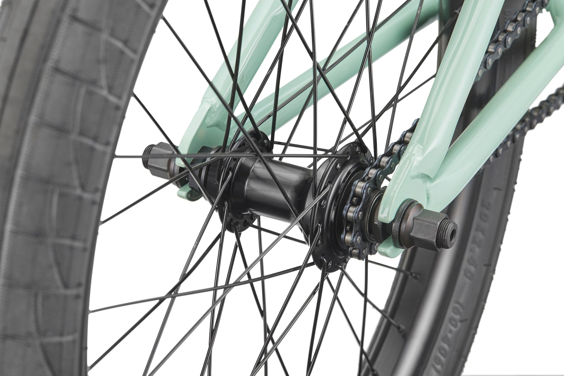 Close-up of the Burgess rear wheel, showing spokes, black hub, chain, and mint green frame.