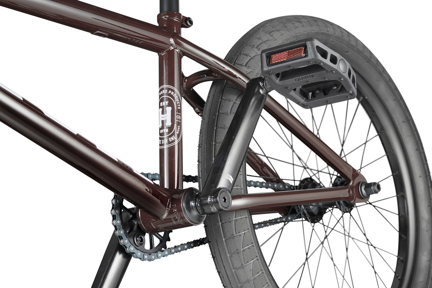 Close-up of a maroon Clairemont BMX bike showing the frame, rear wheel, pedal, chain, crankset, and visible logo.