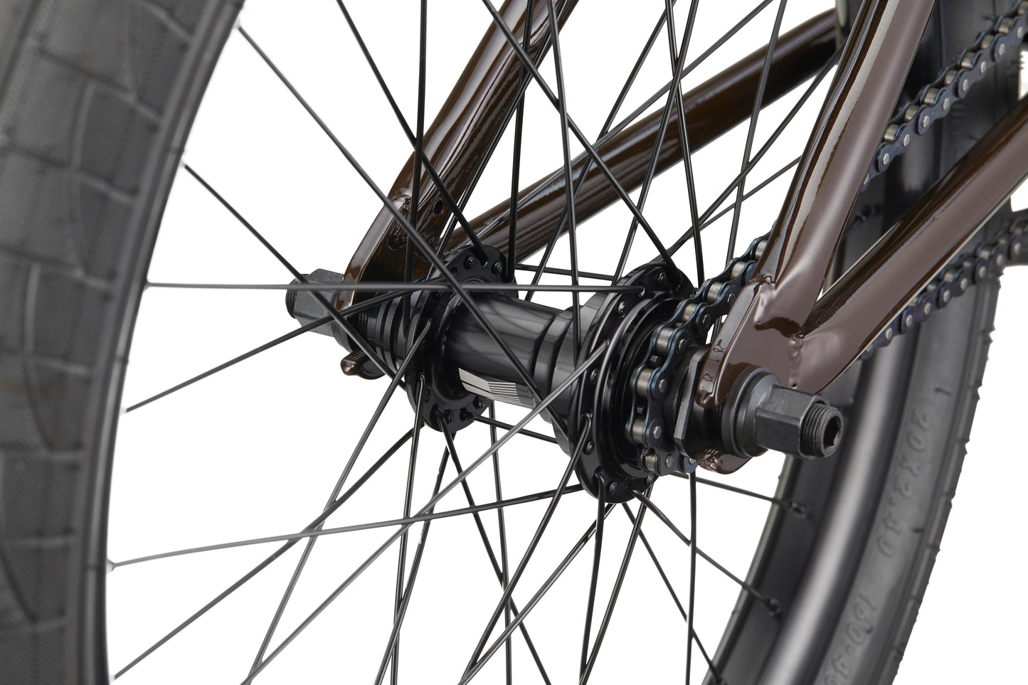 Close-up of the Clairemont bike’s rear wheel hub, spokes, chain, and tire, highlighting its metal frame and competition features.