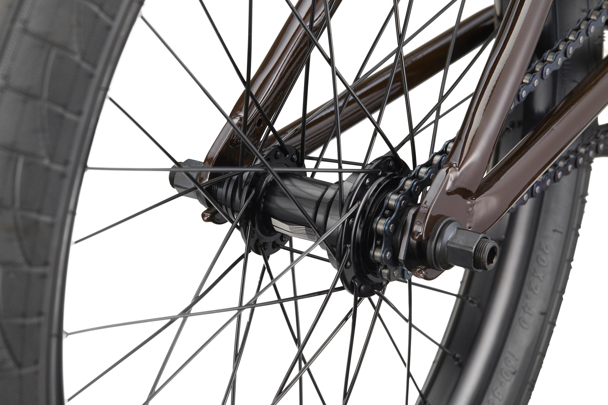 Close-up of the Clairemont bike’s rear wheel hub, spokes, chain, and tire, highlighting its metal frame and competition features.