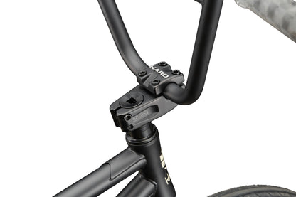 Close-up of a black Dana street bike handlebar and stem, highlighting Dana branding and pro-level performance details.