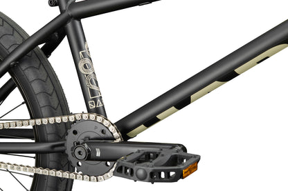 Close-up of Dana street bike's frame, chain, pedal, and rear wheel with custom colors and decorative graphics.