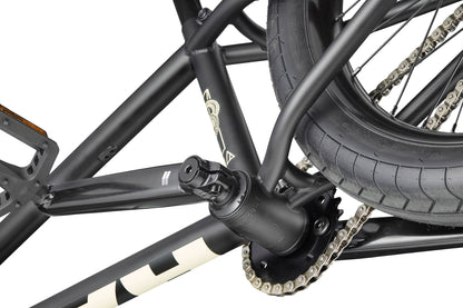 Close-up of Dana's black crankset, rear wheel, and chain, designed for pro-level street performance on a white background.