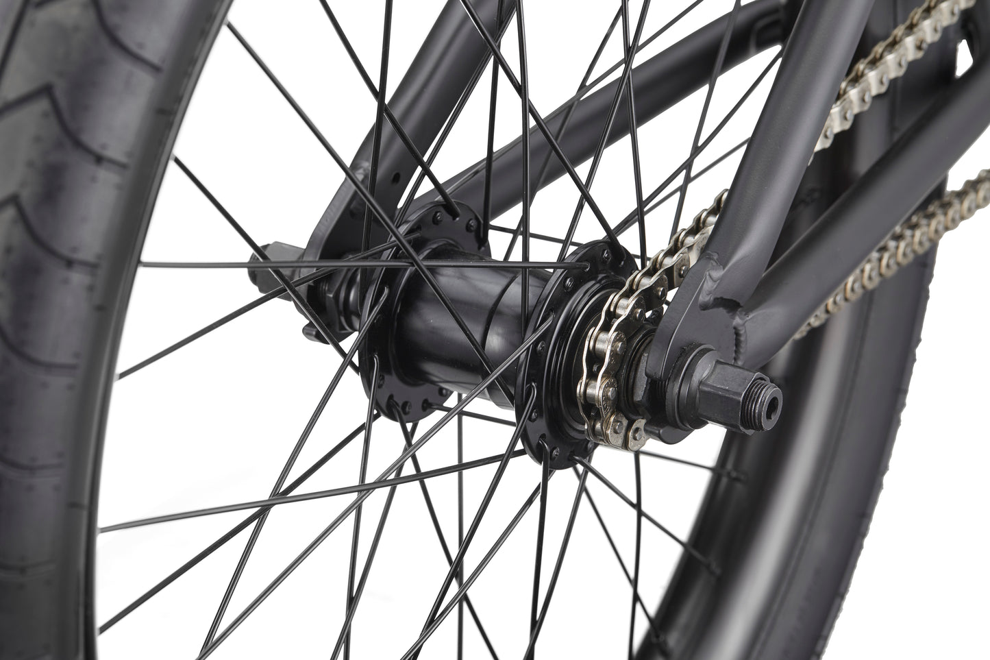 Close-up of Dana's rear wheel, showing pro-level street performance with black spokes, hub, chain, and tire.