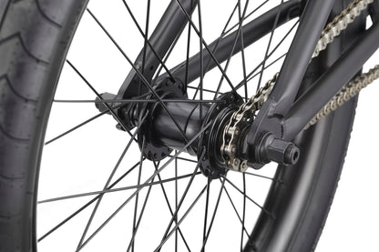Close-up of Dana's rear wheel, showing pro-level street performance with black spokes, hub, chain, and tire.