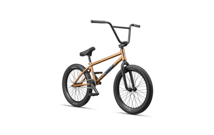 The Haro Dana BMX is a bronze street bike with black tires, seat, and handlebars for pro-level riding, shown on a white background.