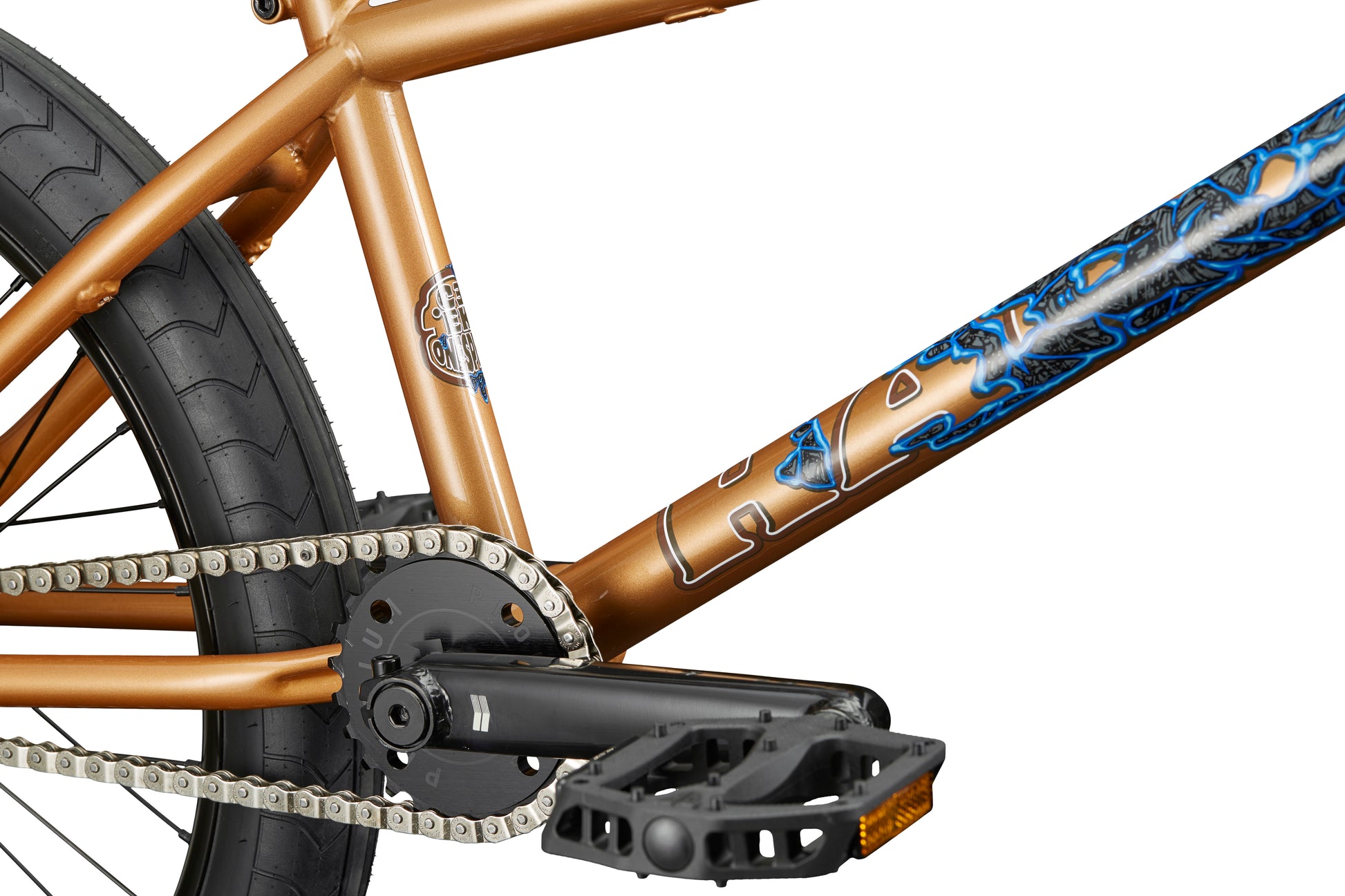 Close-up of the Dana bronze BMX bike frame with blue graphics, highlighting pro-level build, detailed chain, pedal, and rear tire.