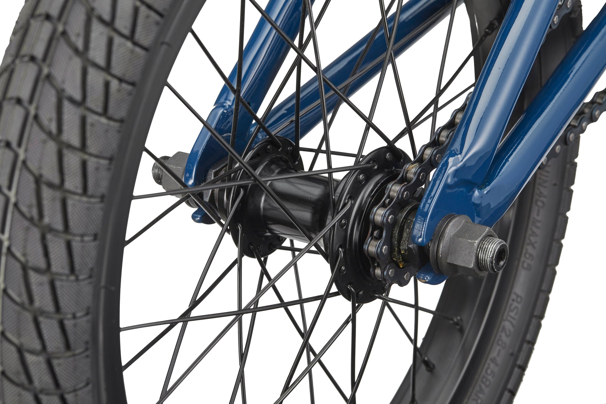 Close-up of the Downtown 16's rear wheel with black spokes, tire tread, gear cogs, and blue frame—great for young BMX riders.