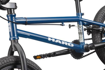 Close-up of the Downtown 16 BMX bike frame in blue, showing handlebars, pedals, chain, and black tires.