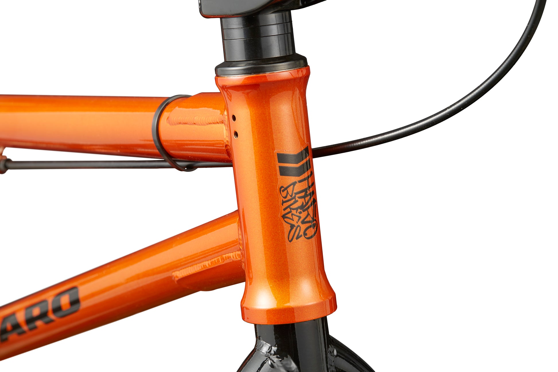 Close-up of a Downtown 16 orange BMX frame showing the head tube and black front brake cable.