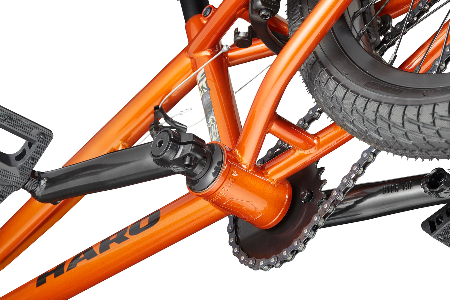 Close-up of the Downtown 16 BMX bike frame, showing the crankset, chainring, chain, and rear tire—ideal as a first bike.