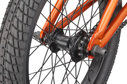 Close-up of a black BMX wheel hub and spokes on the Downtown 16's orange frame.