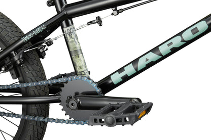 Close-up of the Downtown 18 black BMX bike, highlighting its chain, pedal, rear tire, and frame graphics—perfect for small riders.