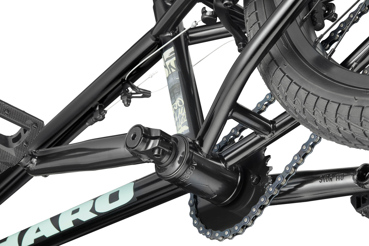 Close-up of the Downtown 18 BMX crank, chain, rear tire, and frame, highlighting the bike's gear mechanism on a white background.