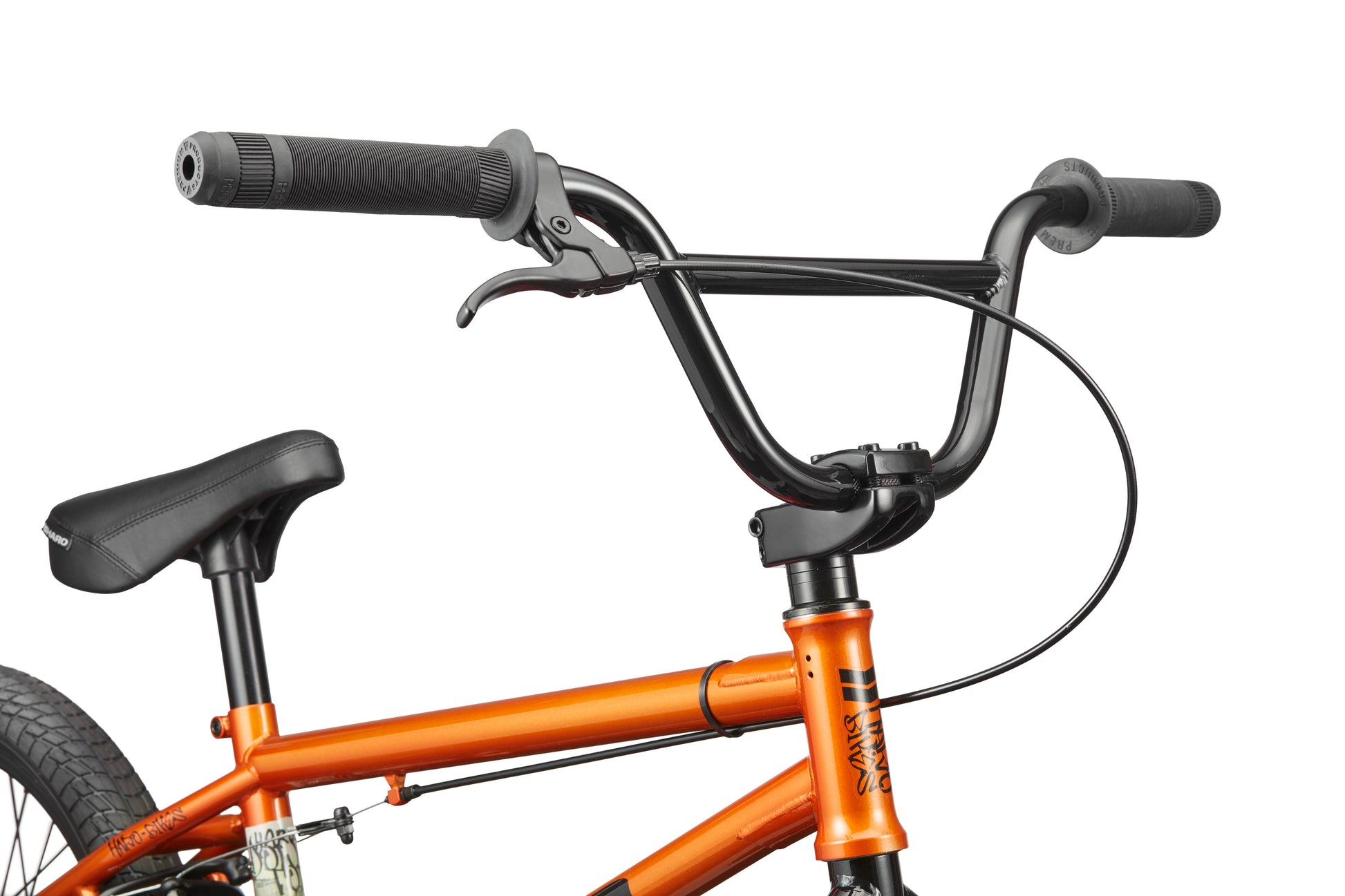 Close-up of a black handlebar and brake lever on an orange Downtown 18 BMX, showing part of the seat and rear tire.