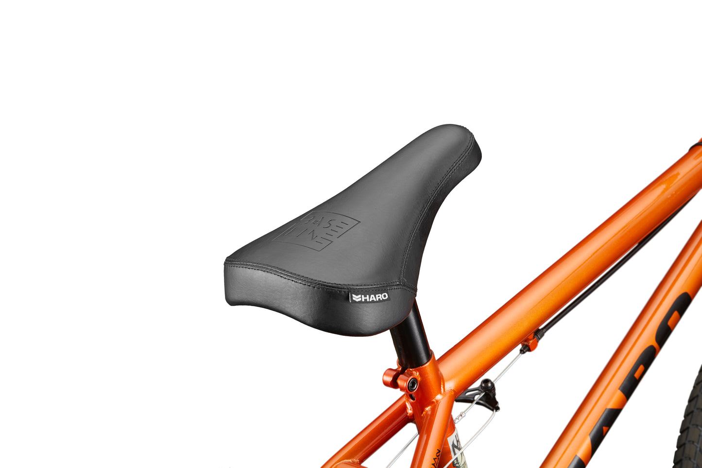 Close-up of Downtown 18's black BMX seat on an orange frame, ideal for small riders, against a white background.