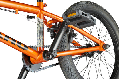 Close-up of the Downtown 18 BMX: bright orange frame, chain, pedals, and back wheel—ideal for small riders who love bold style.