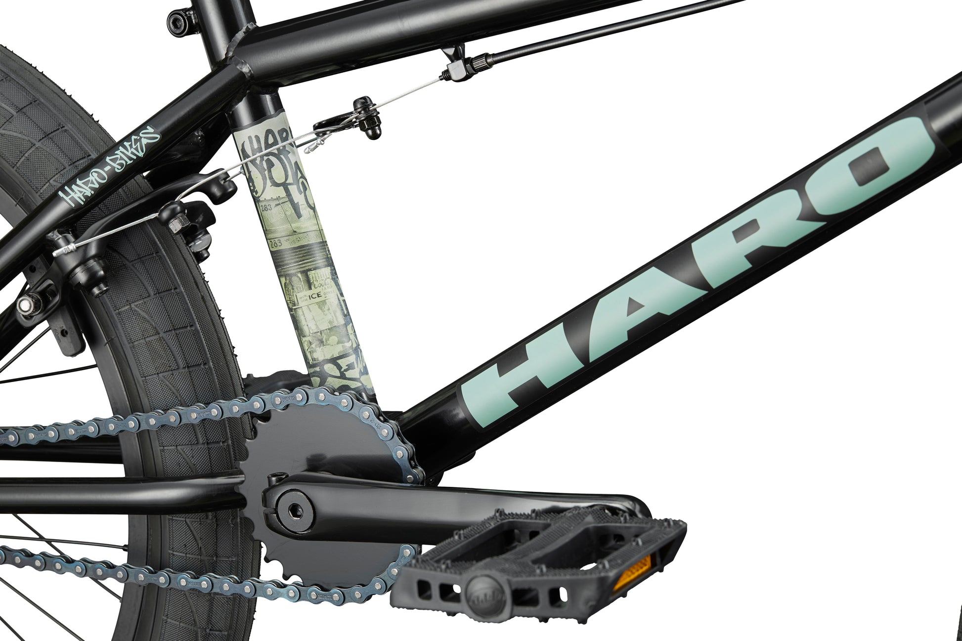 Close-up of a Downtown 20 BMX bike, showing the pedal, chain, rear wheel, and logo—perfect for entry-level riders.