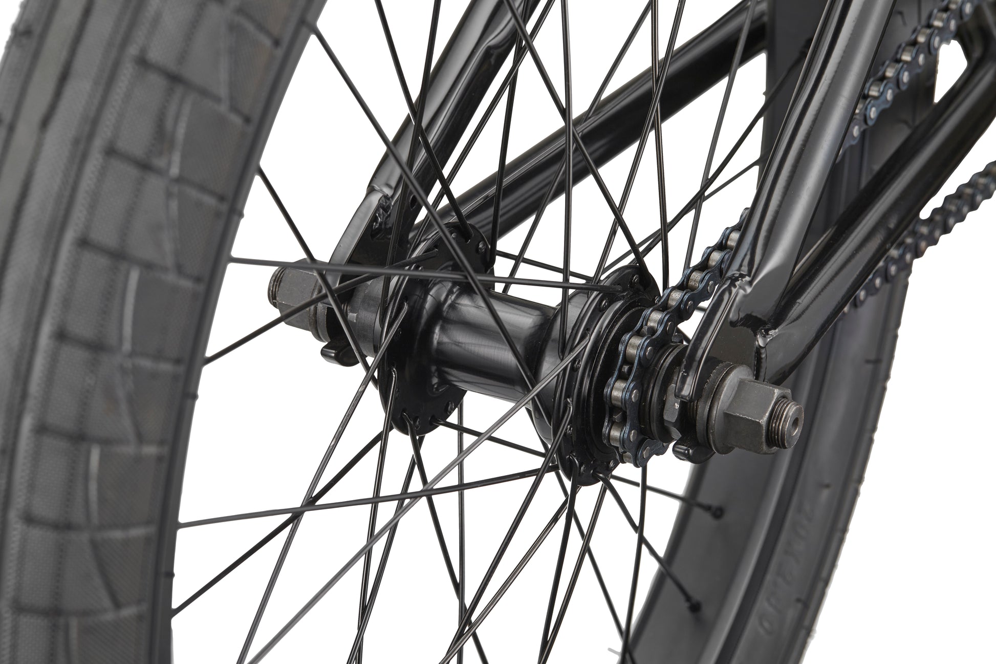 Close-up of the Downtown 20 BMX bike’s rear wheel with spokes, chain, and tire—ideal for beginners—against a white background.