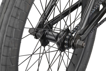 Close-up of the Downtown 20 BMX bike’s rear wheel with spokes, chain, and tire—ideal for beginners—against a white background.