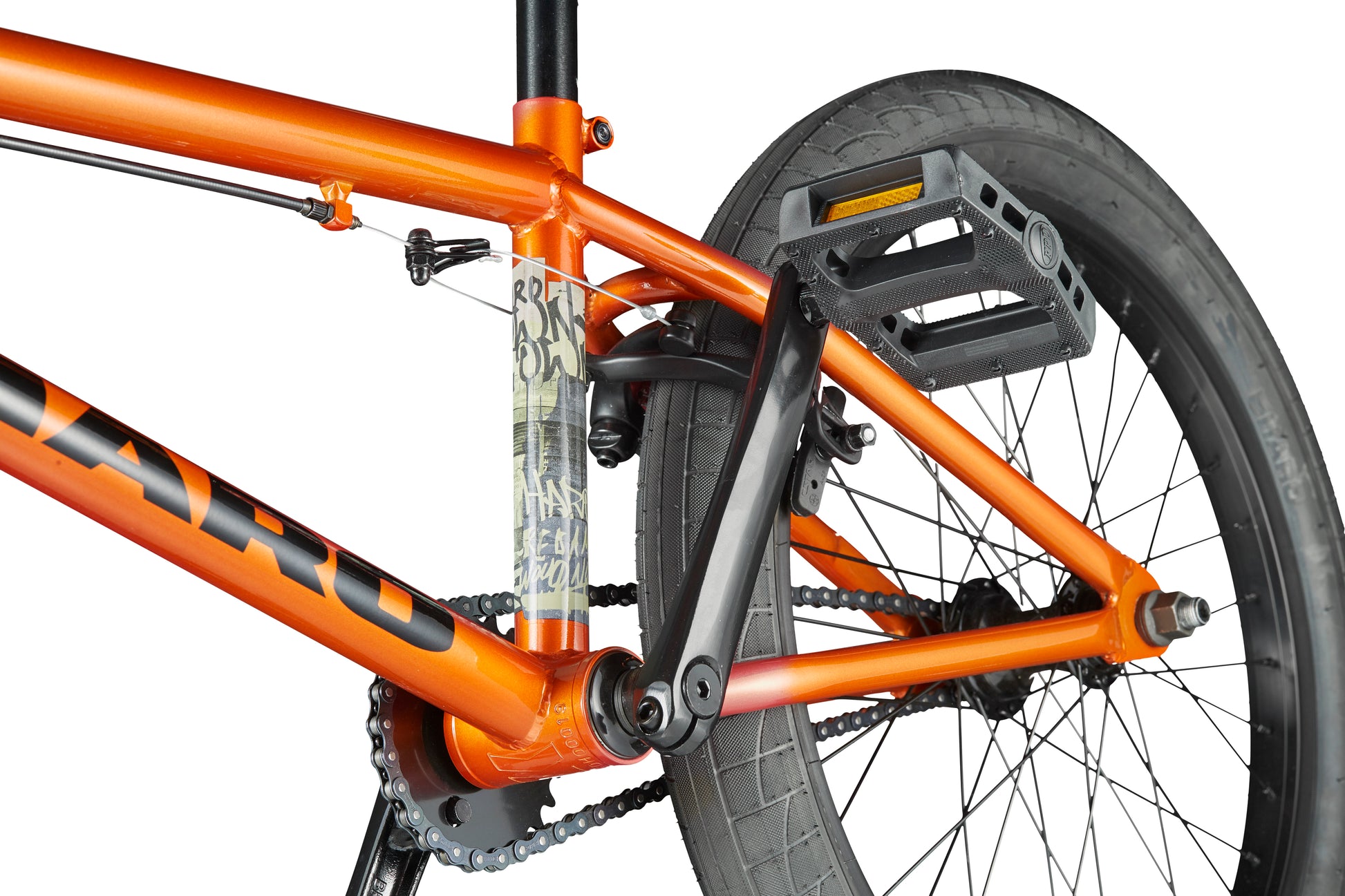 Close-up of the rear section of an orange Haro Downtown 20 BMX bike, showing the wheel, pedal, frame, chain, and seat post.