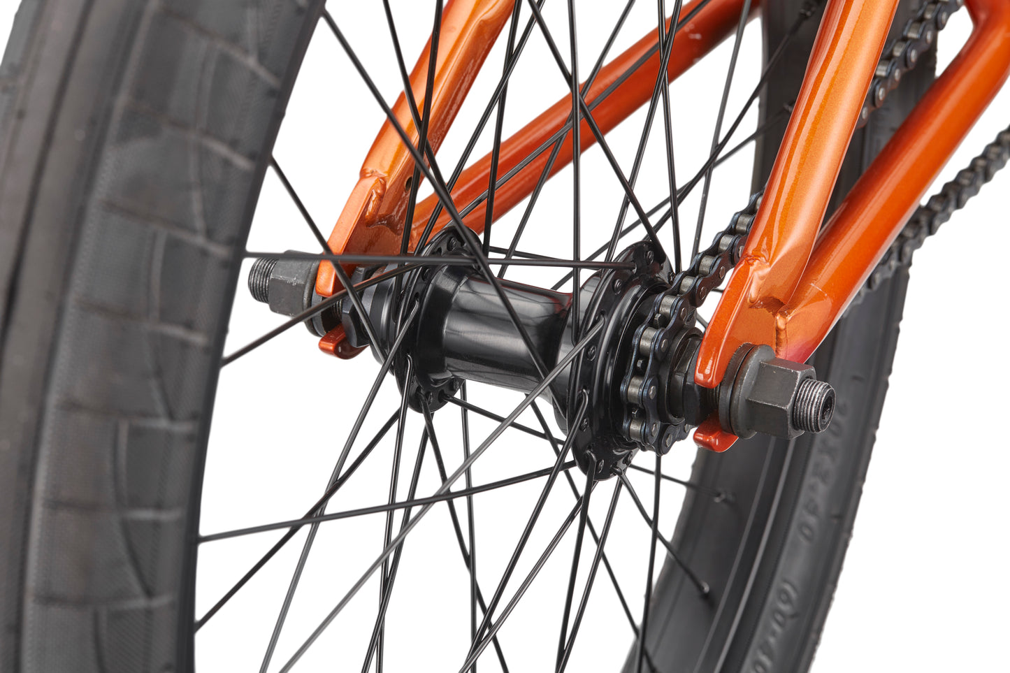 Close-up of a Downtown 20 black BMX rear wheel hub with orange frame, black spokes, and part of the tire and chain.