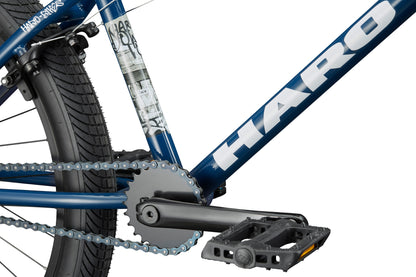 Close-up of the Downtown 24 BMX bike with 24” wheels, showcasing its modern features, chain, pedals, and HARO logo.