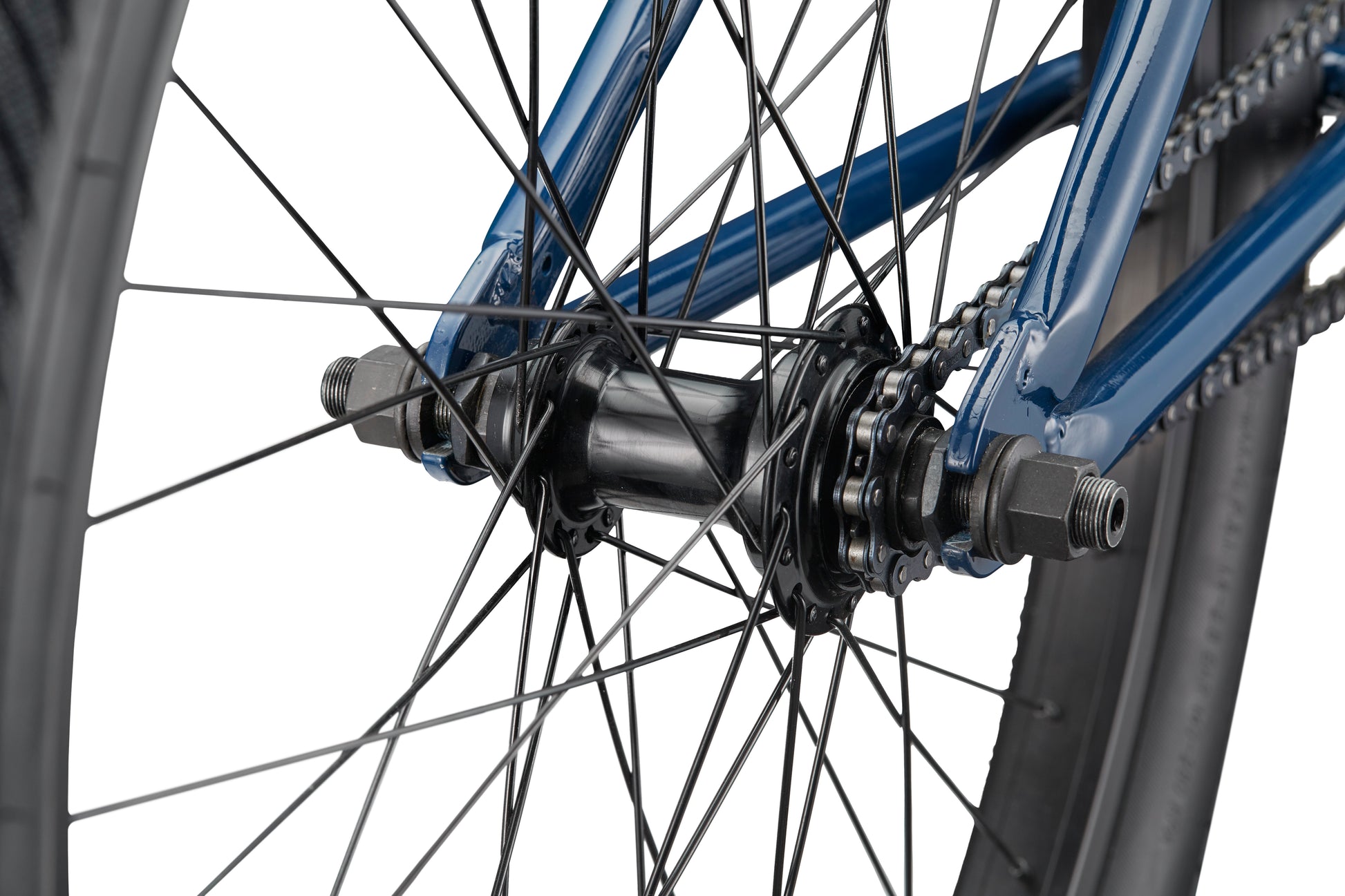 Close-up of the Downtown 24’s blue rear wheel hub with spokes, chain, and axle bolts set against a white background.