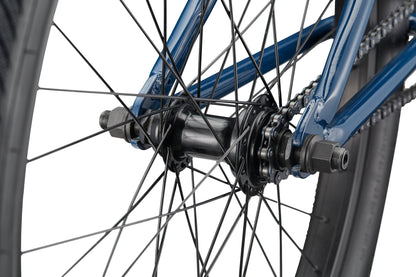 Close-up of the Downtown 24’s blue rear wheel hub with spokes, chain, and axle bolts set against a white background.