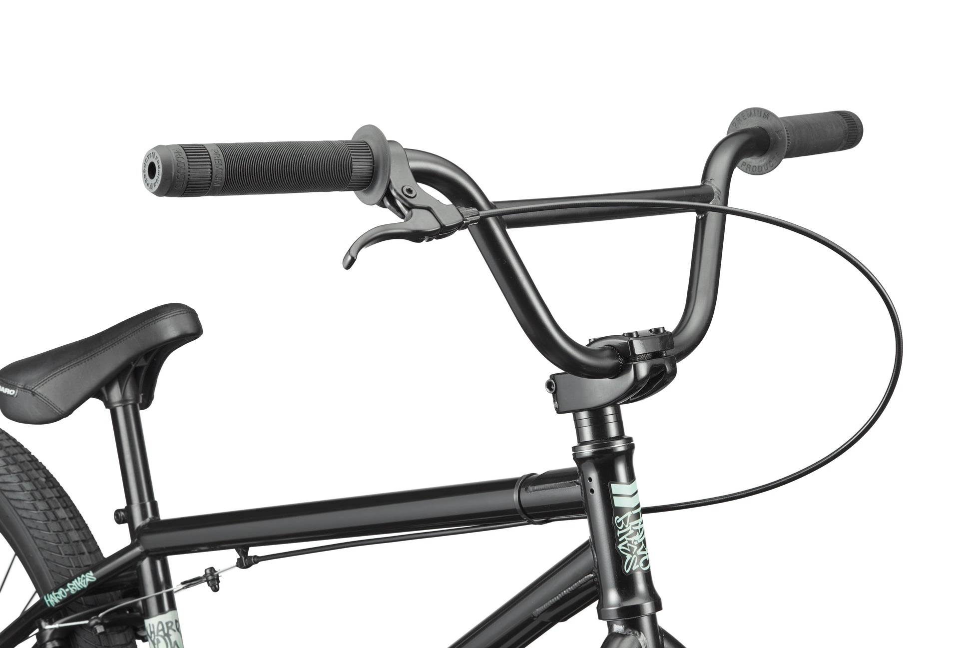 Close-up of Downtown 24 BMX bike’s handlebars, brake lever, and seat against a white background, highlighting modern versatility.