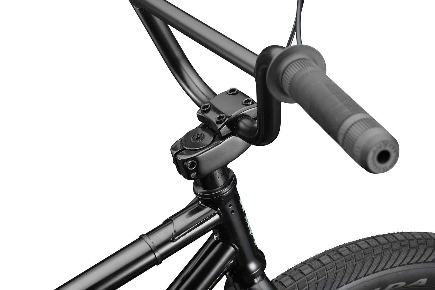 Close-up of a black Downtown 24 BMX handlebar, stem, and front tire with textured grip, showcasing modern versatility.
