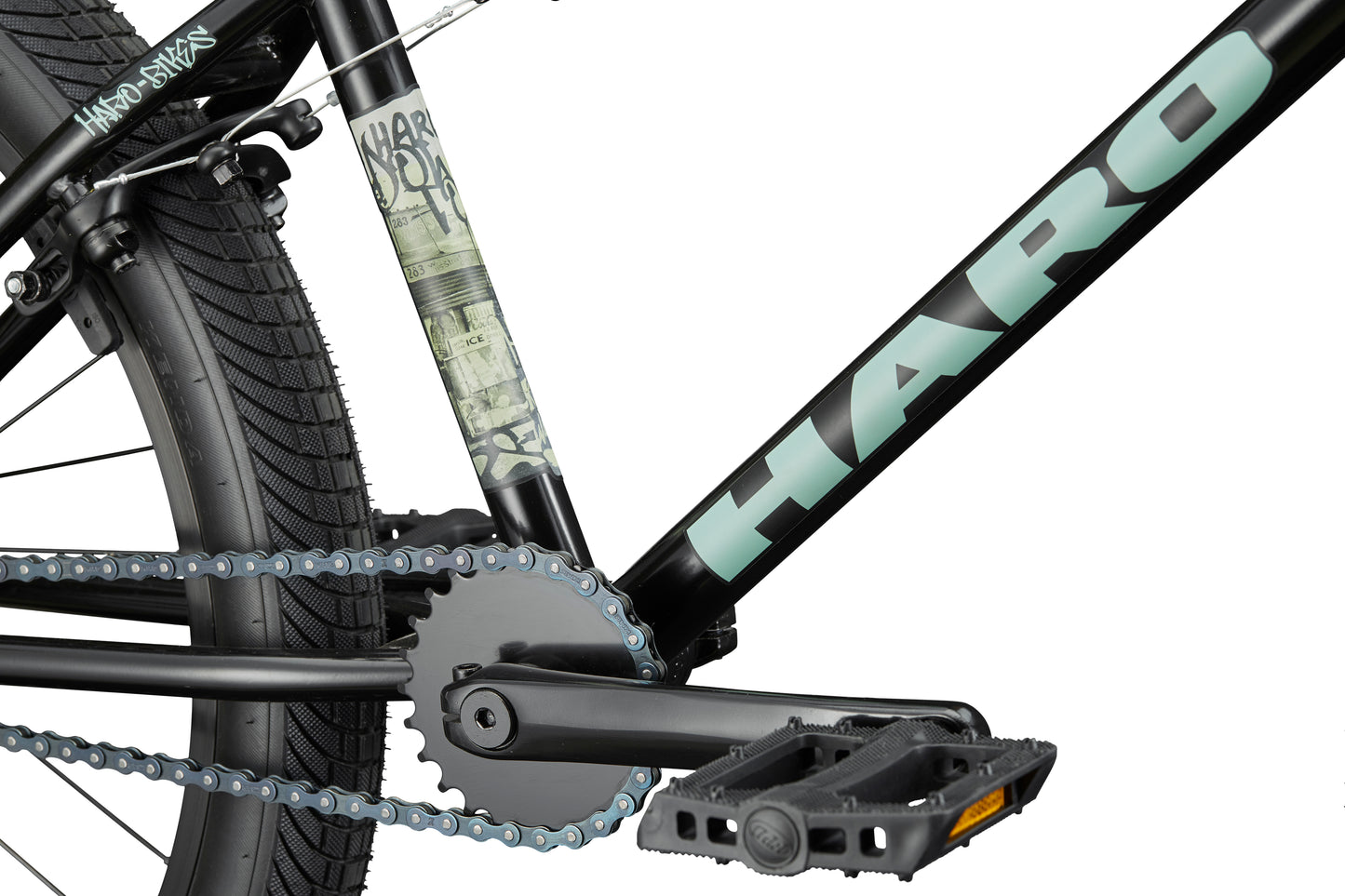 Close-up of a Haro Downtown 24 BMX with black frame, 24" wheels, visible pedal, chain, crank, logo, and tire.