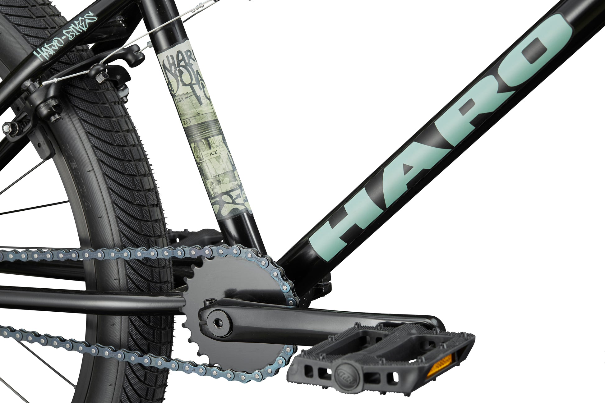 Close-up of a Haro Downtown 24 BMX with black frame, 24" wheels, visible pedal, chain, crank, logo, and tire.