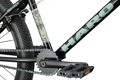 Close-up of a Haro Downtown 24 BMX with black frame, 24" wheels, visible pedal, chain, crank, logo, and tire.