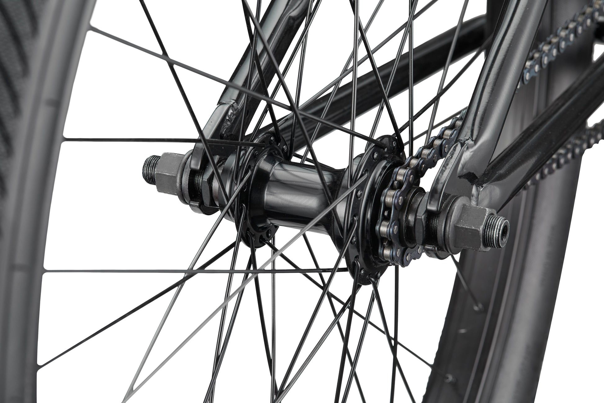 Close-up of a Downtown 24 BMX wheel hub and spokes, highlighting the chain, axle nuts, and frame for modern versatility.