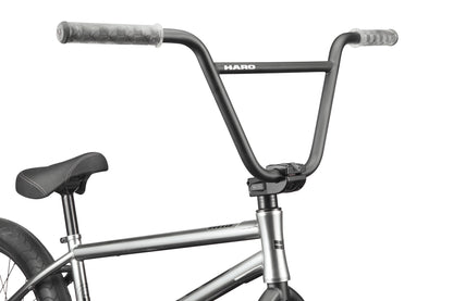 Close-up of a black street BMX bike handlebar and seat, with Hoover branding visible on the handlebar.