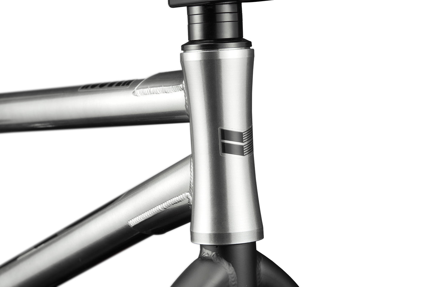Close-up of the Hoover BMX frame in silver, featuring the head tube, welds, and a simple geometric front logo.
