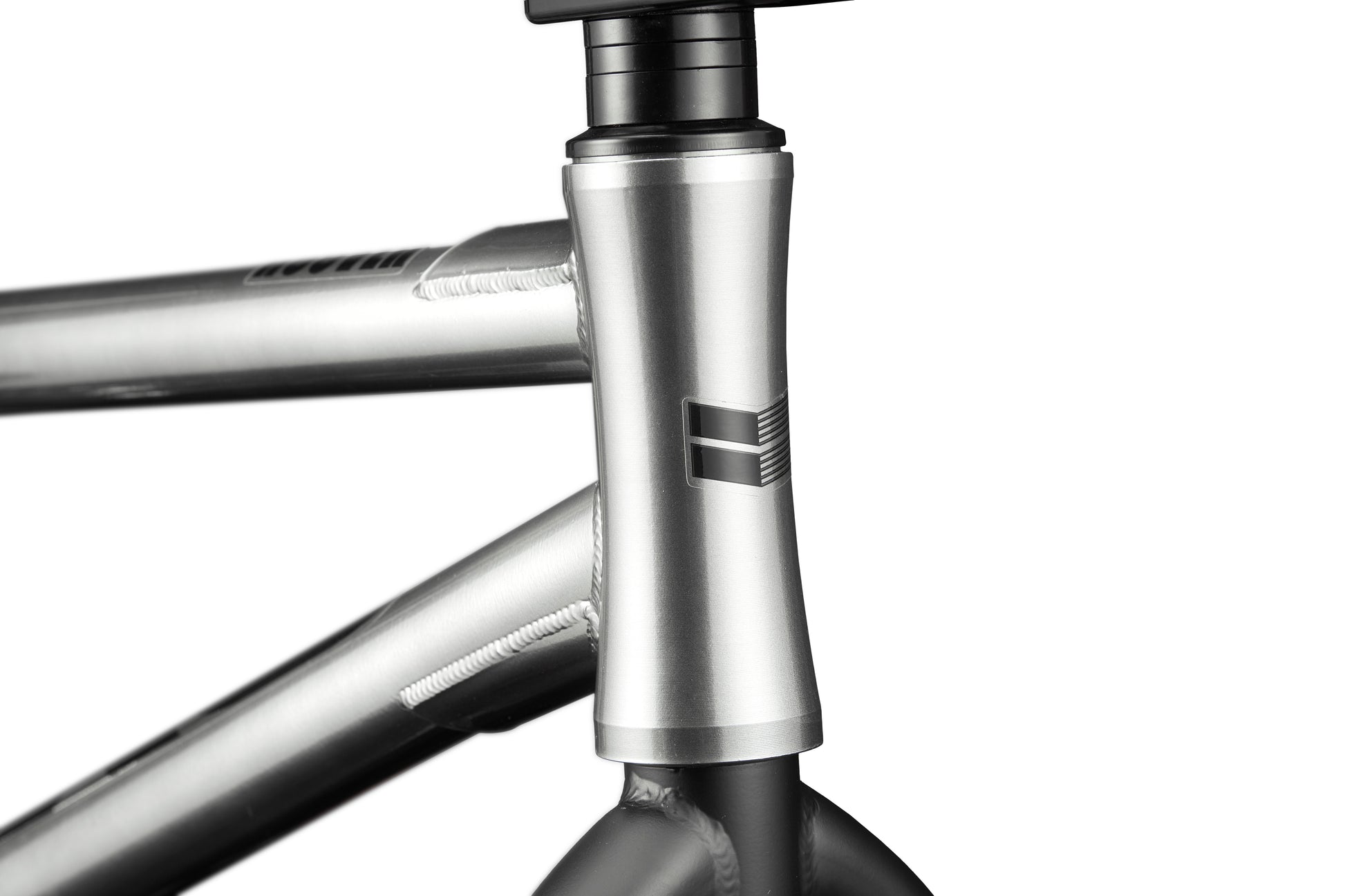 Close-up of the Hoover BMX frame in silver, featuring the head tube, welds, and a simple geometric front logo.