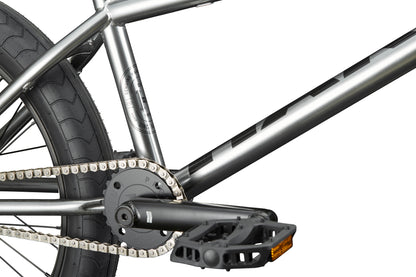 Close-up of a Hoover street BMX’s rear wheel, chain, crankset, and pedal with hub guards against a white background.