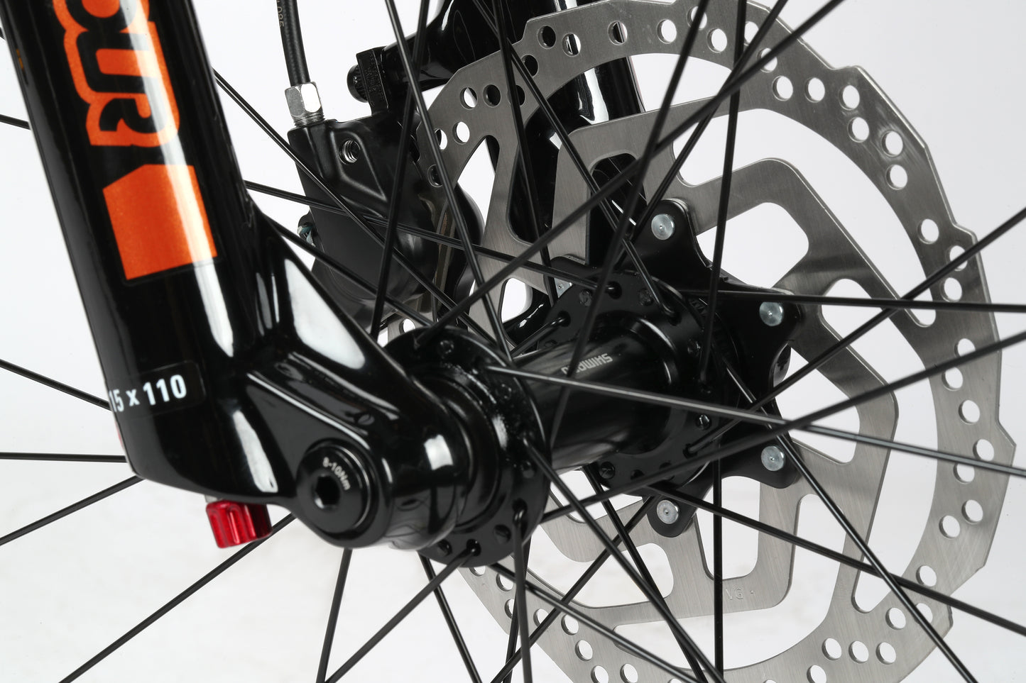 Close-up of a Double Peak 2s aluminum frame and front wheel hub, highlighting mechanical details and the SR Suntour fork.