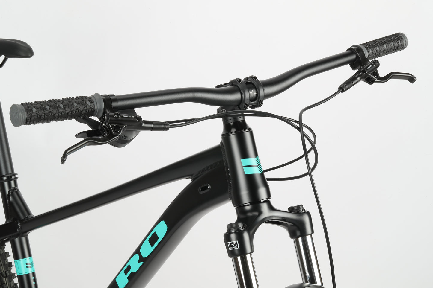 A close-up of Double Peak 3s handlebars and front suspension displays its PRO brand name in light blue on a white background.