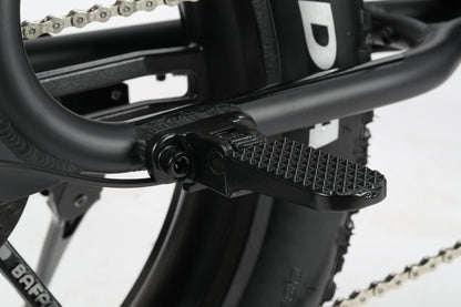 A close-up of the Skwad 1 pedal with a textured surface attached to an e-bikes sleek black frame.