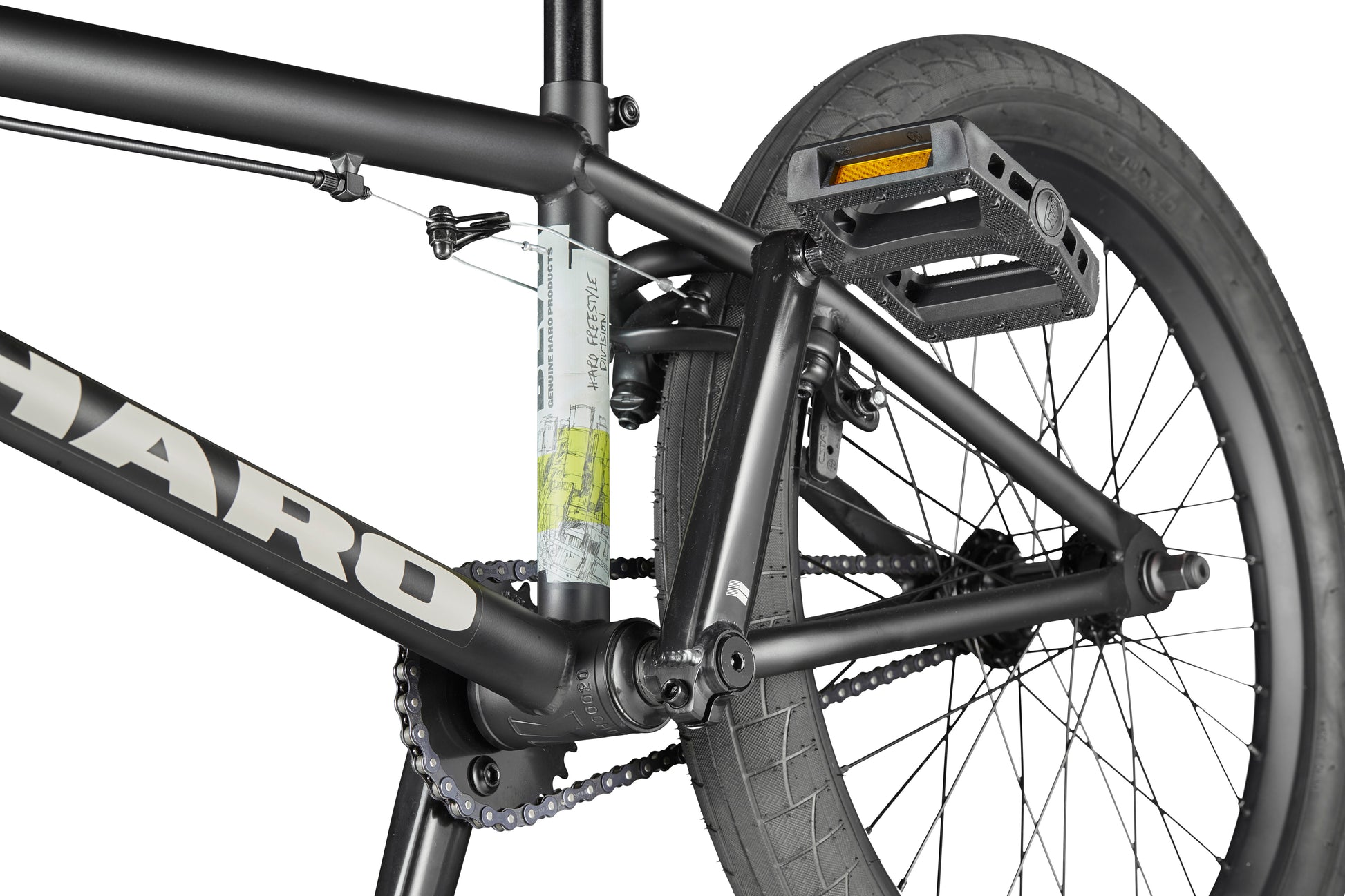 Close-up of the BLVD bike’s rear wheel, pedal, and frame, highlighting the chain and tire tread for all-around performance.