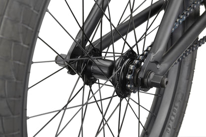 Close-up of the BLVD bike's rear wheel, showing its spokes, tire, hub, axle, and part of the chain.